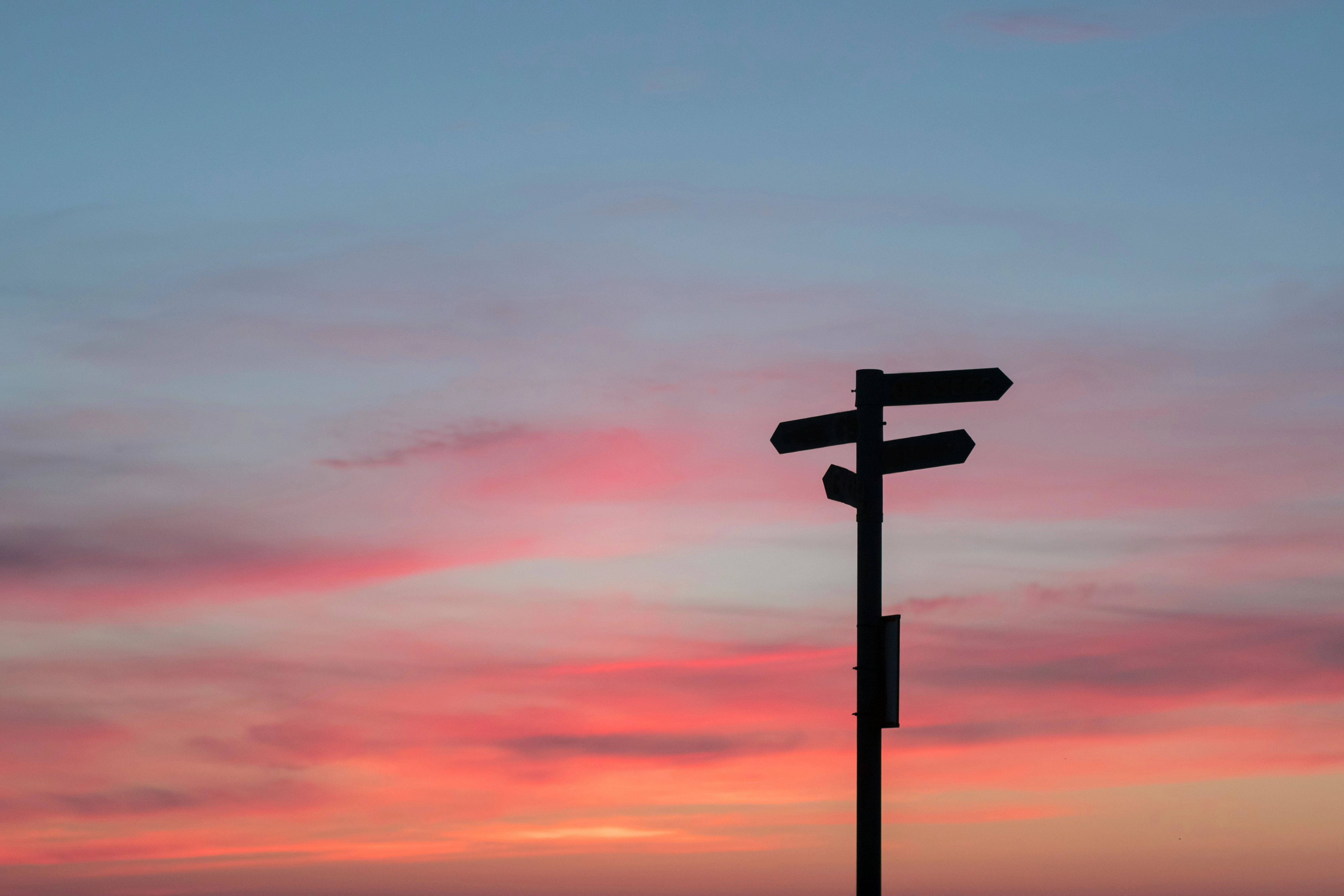 Photo by Javier Allegue Barros - silhouette of road signage during golden hour on Unsplash