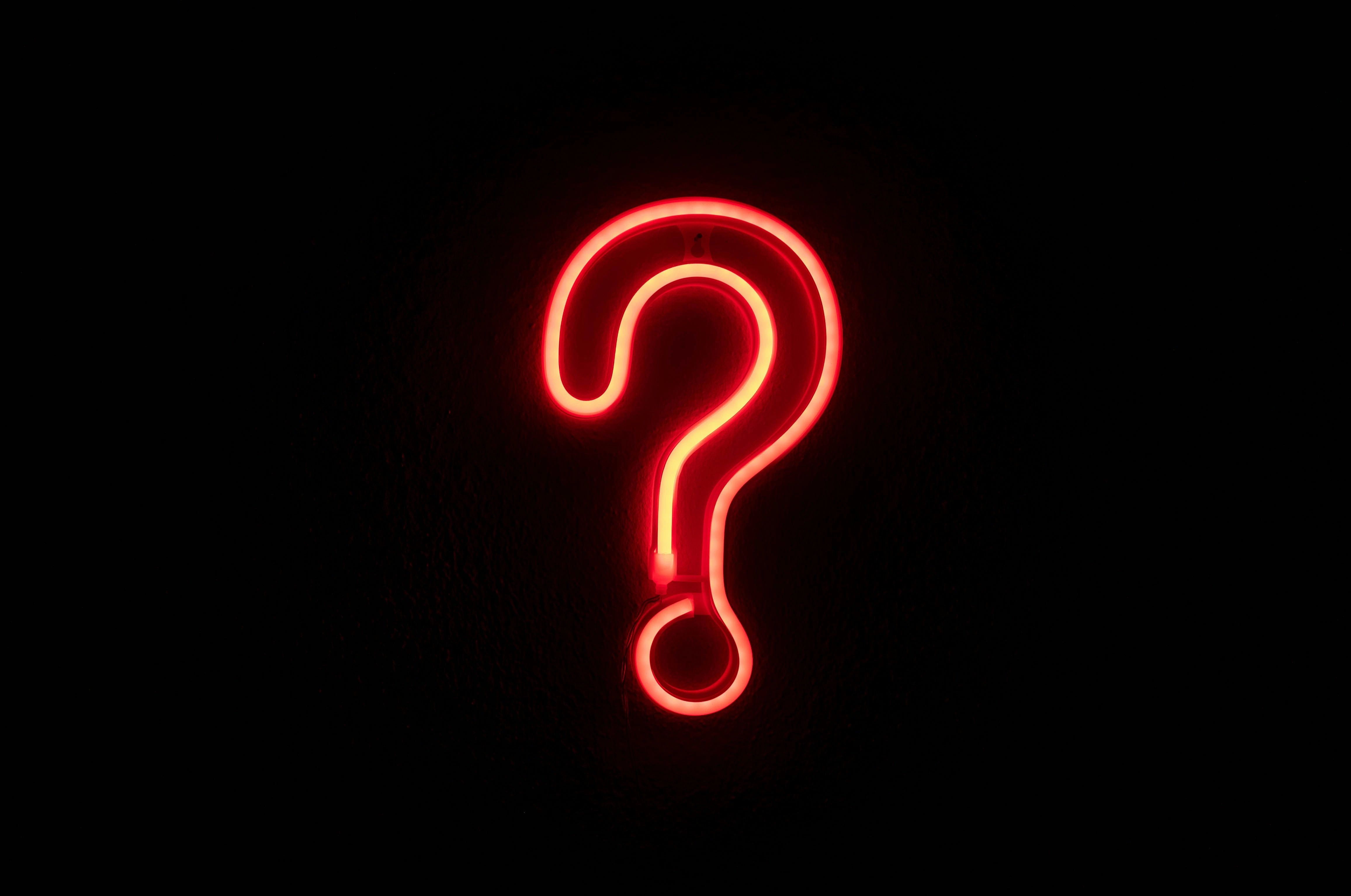 Photo of a neon question mark by Simone Secci on Unsplash