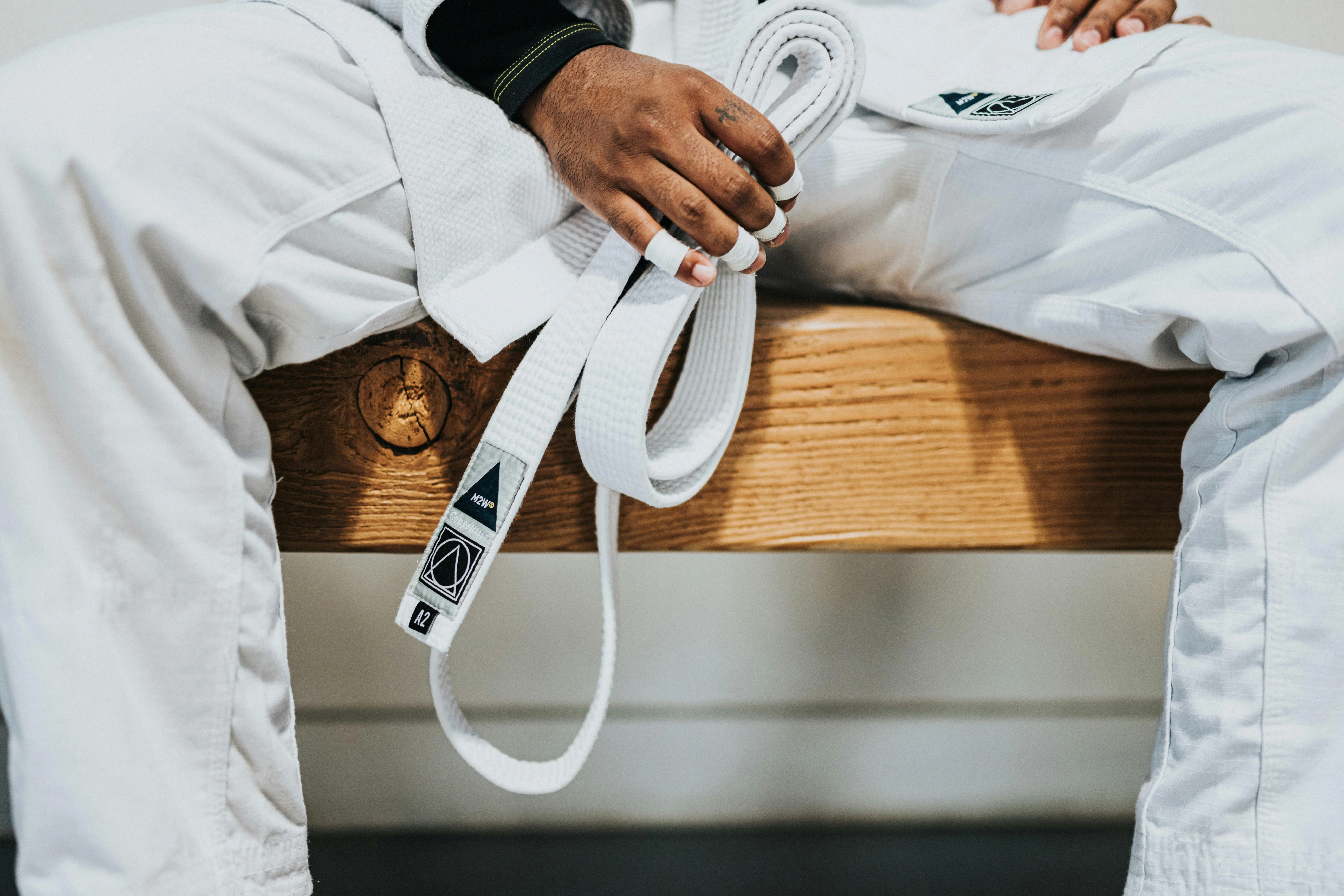A karate fighter sitting on a bench in readiness