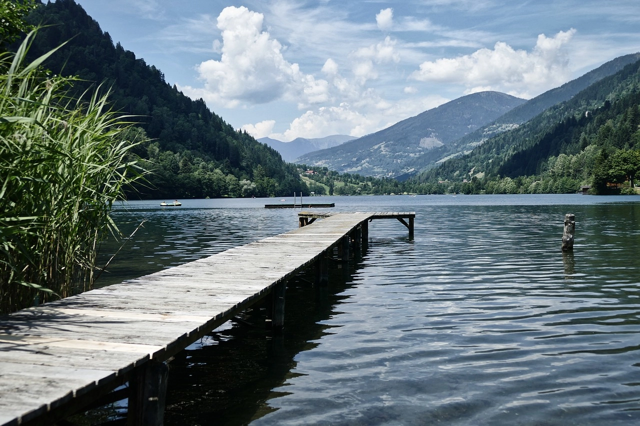 View of a jetty into a lake surrounded by mountains