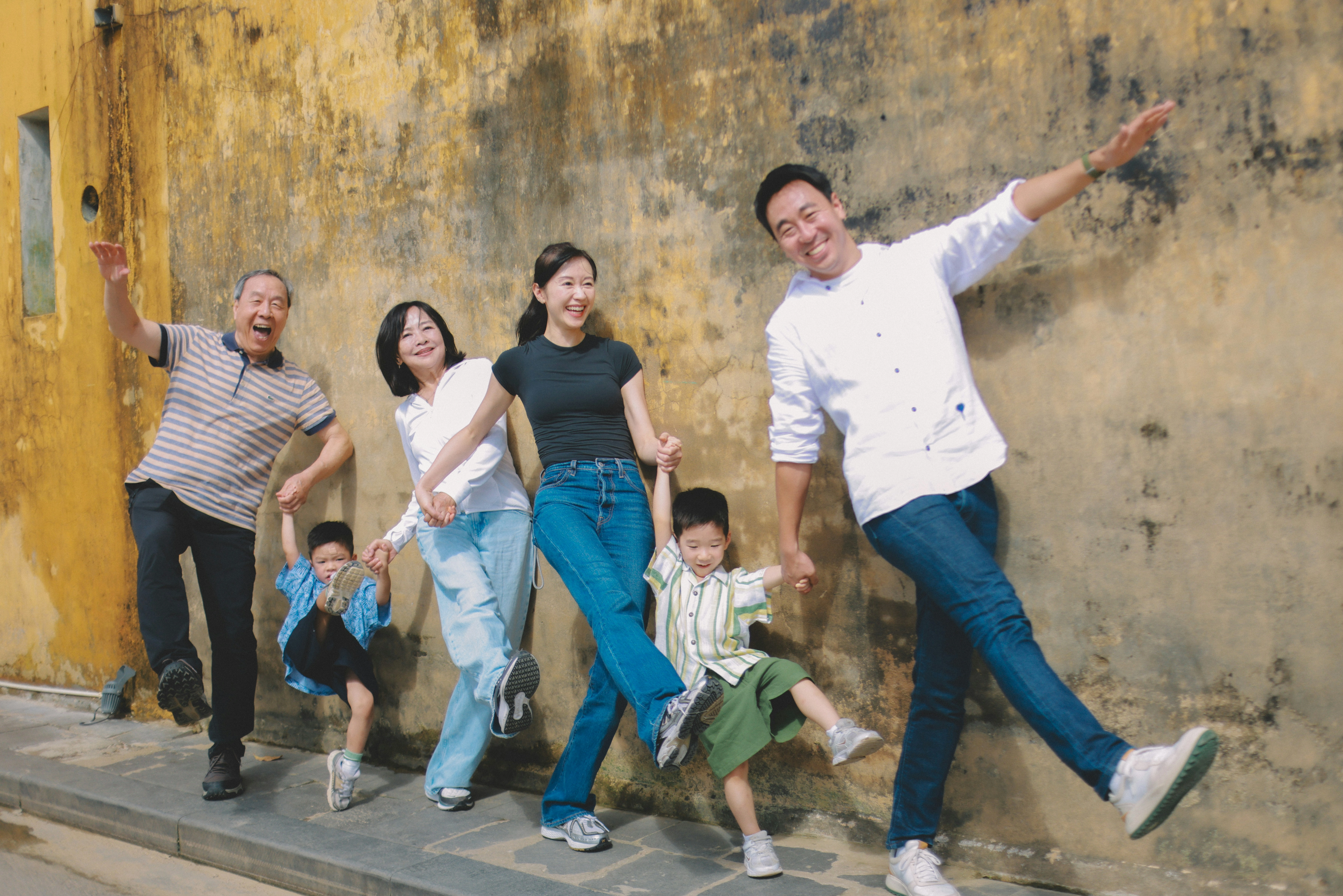 Multi generational family holding hands