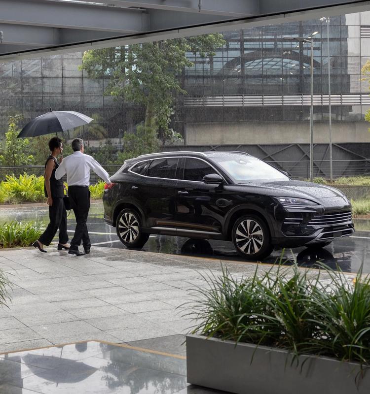 Black Rhino armored SUV with a chauffeur beside it