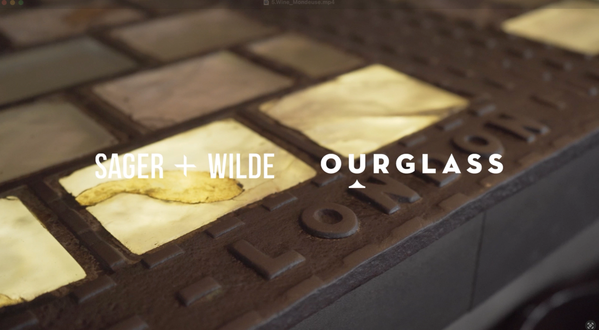 Close-up of the iconic glass-tiled bar top at Sager + Wilde, with the word “London” embossed in metal – a signature detail of this East London natural wine bar and part of the Ourglass video series.