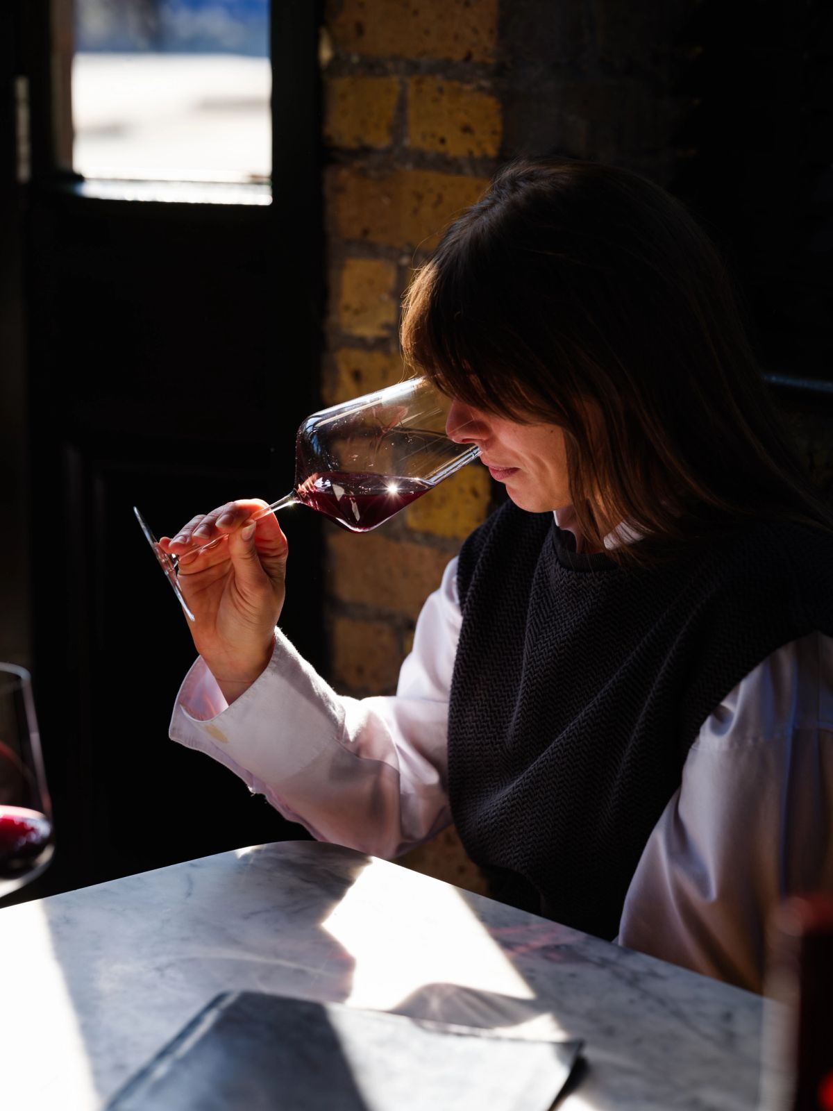Wine lover testing the nose of a glass of red wine