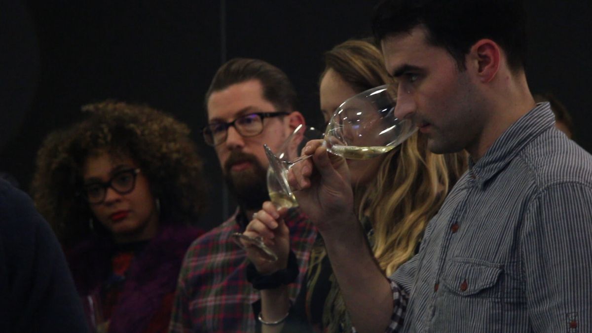 Several people at an Ourglass & Partners wine tasting