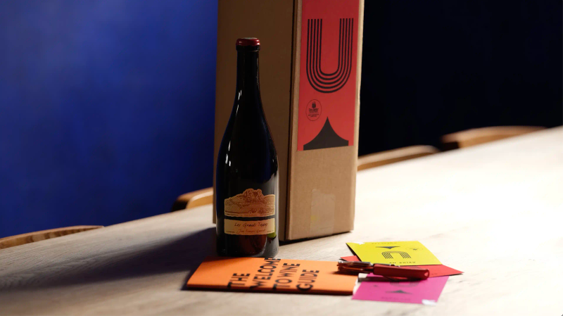 An Ourglass subscription box with a bottle of Les Grands Teppes by Jean Francois Ganevat, the Welcome to Wine guide, tasting notes and branded packaging.