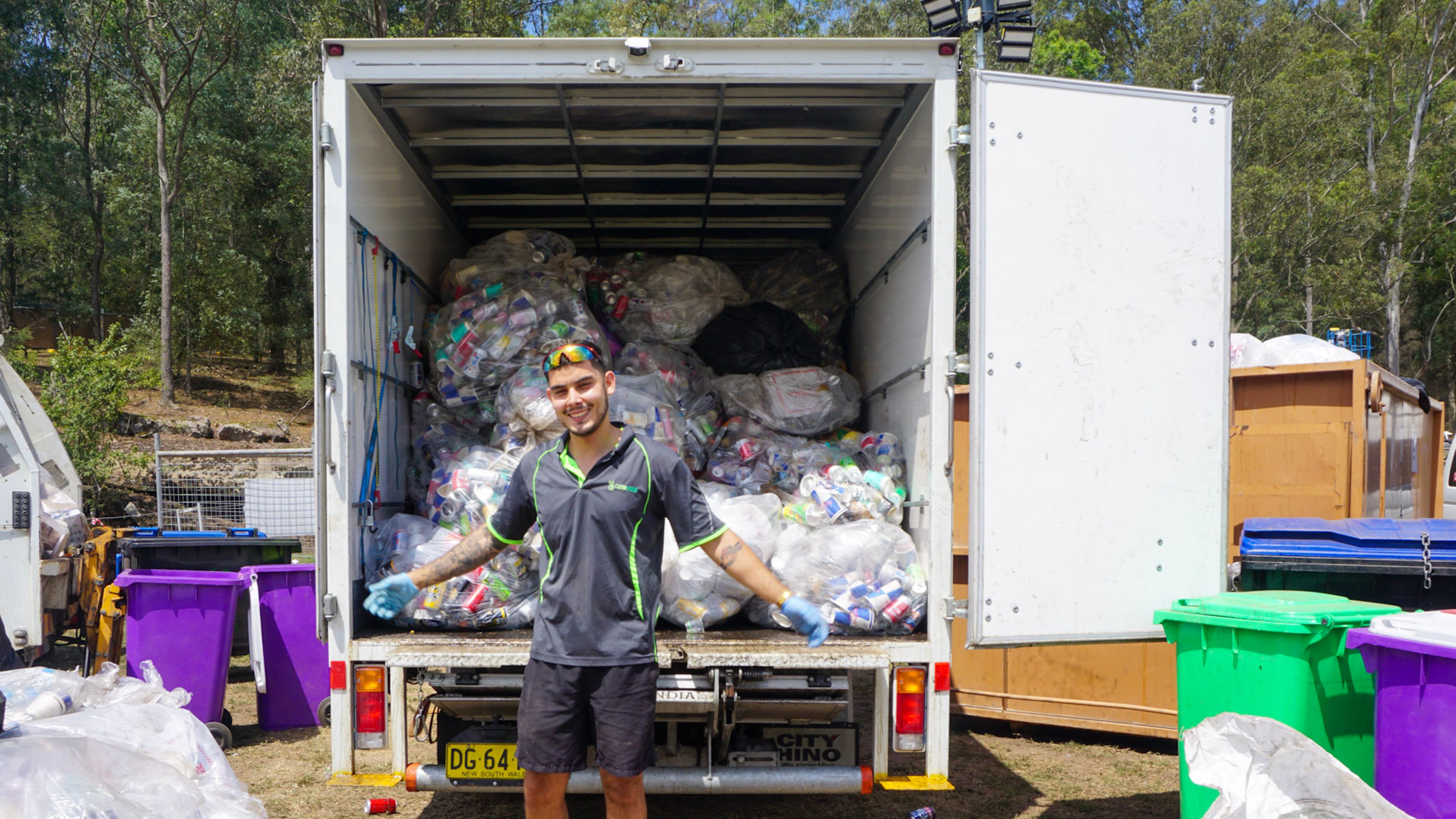 City Return & Earn staff in front of a truck full of empty containers