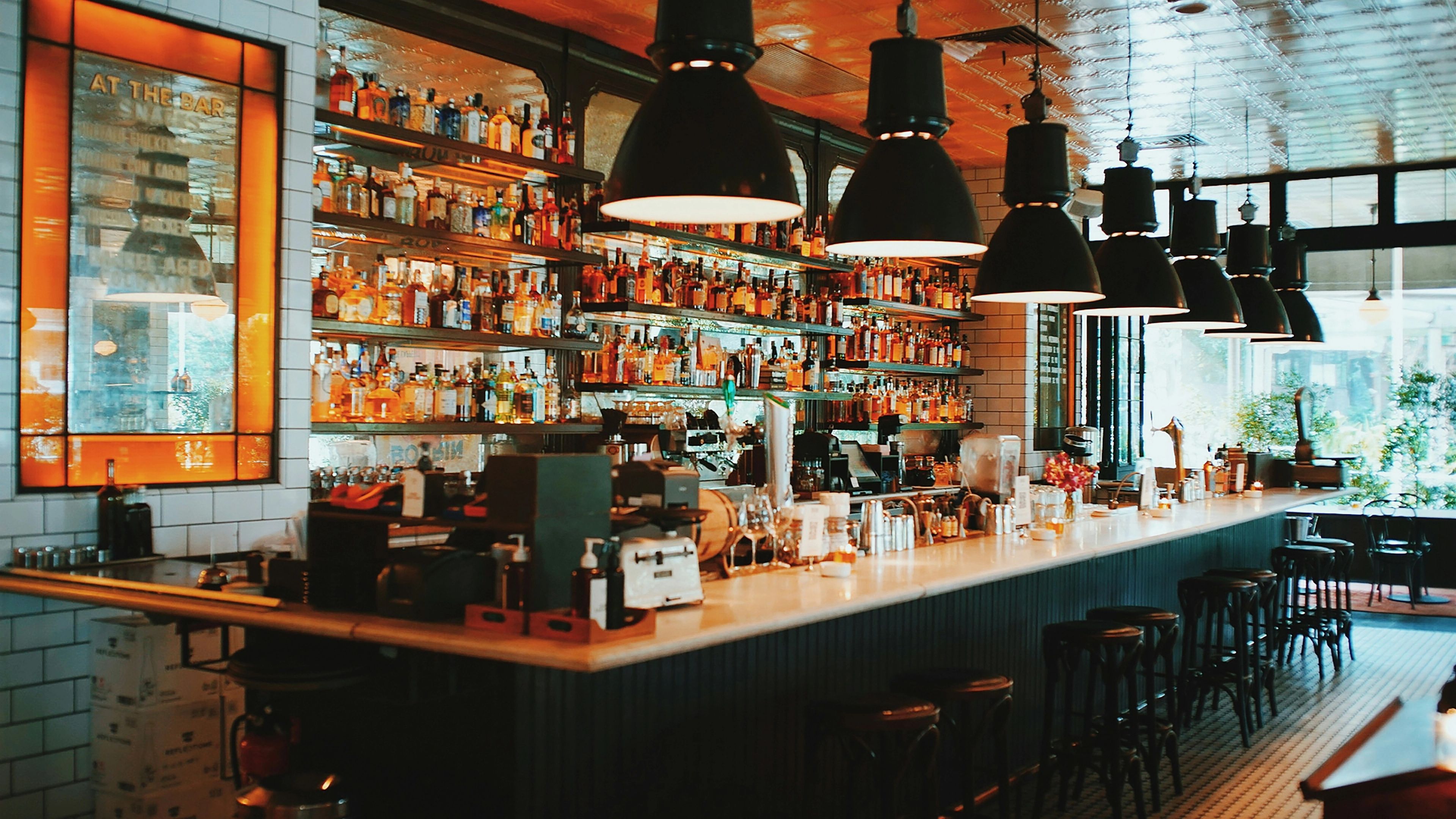 Bar and restaurant counter displaying glass bottle on shelf