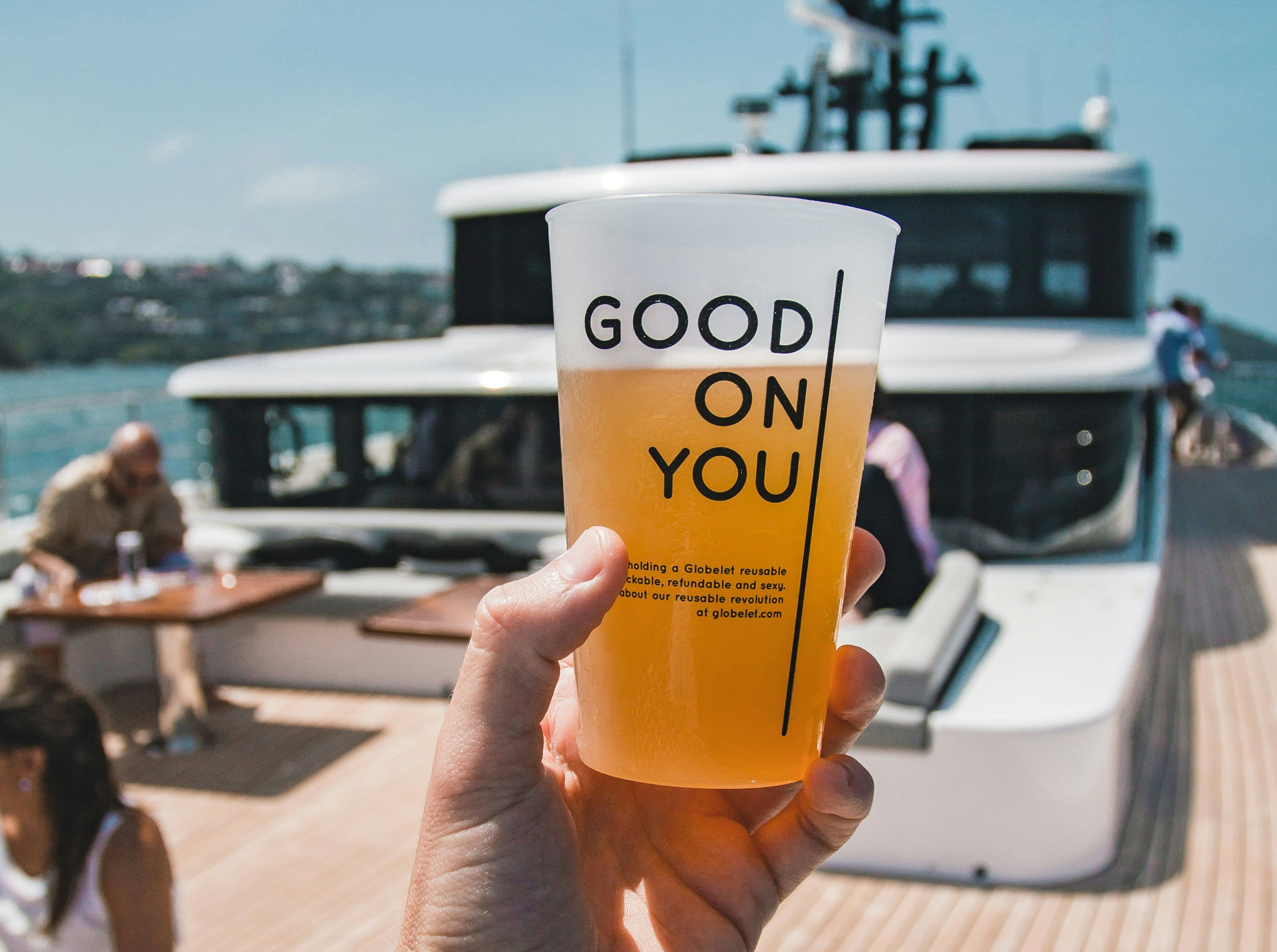 Branded reusable cup on a boat