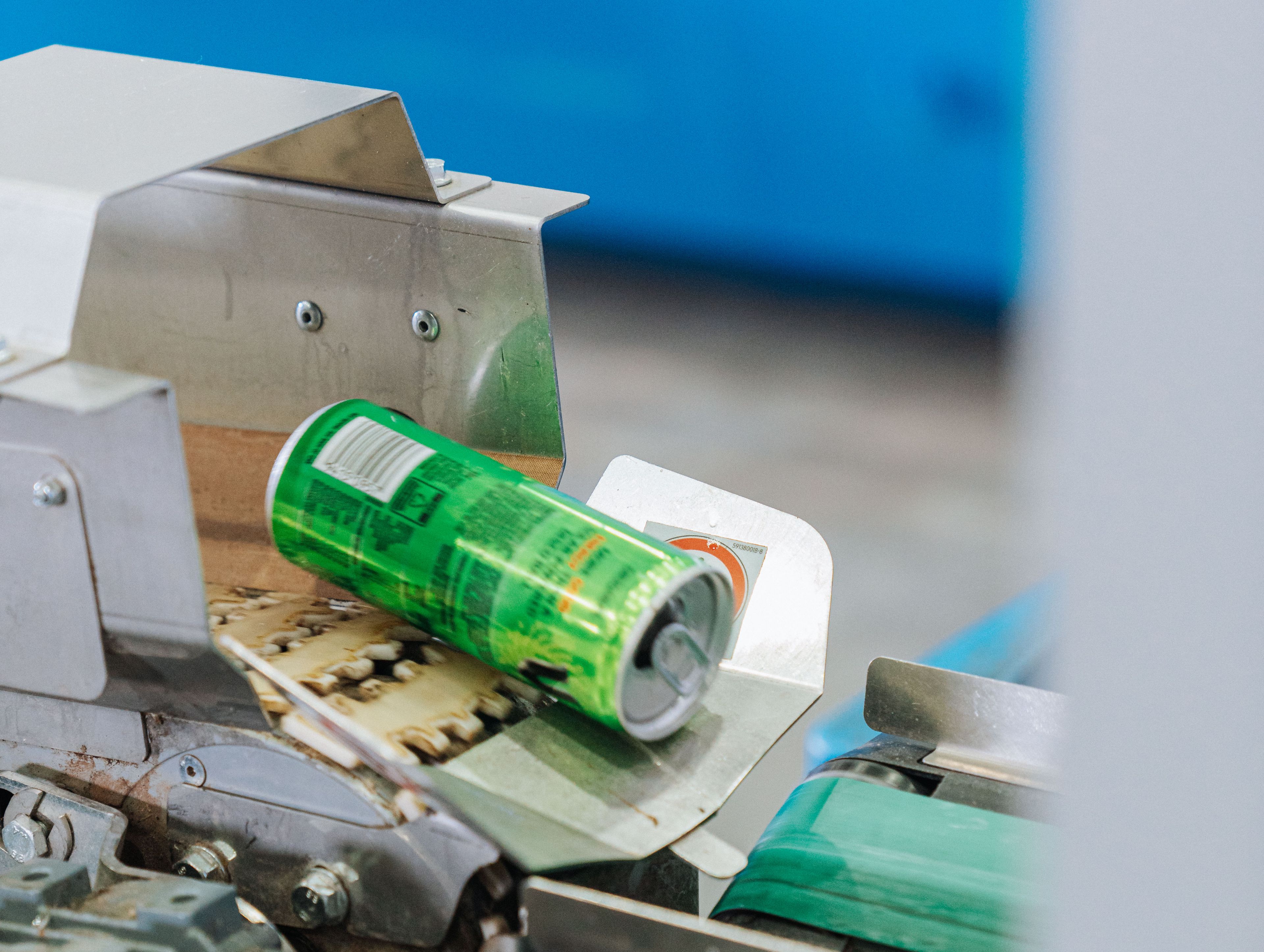 An aluminum can being processed for recycling