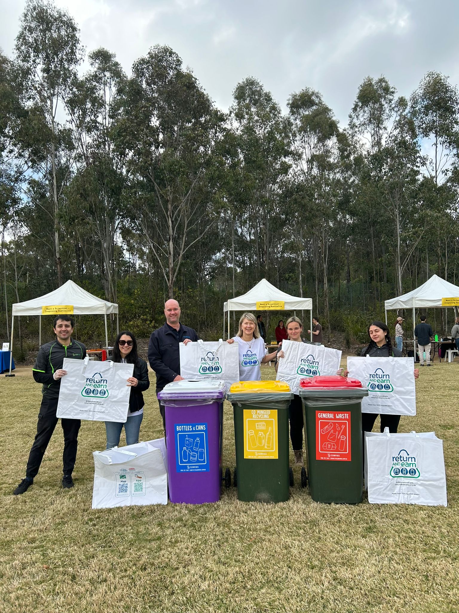 City Return & Earn Team olding bags to collect recyclable containers