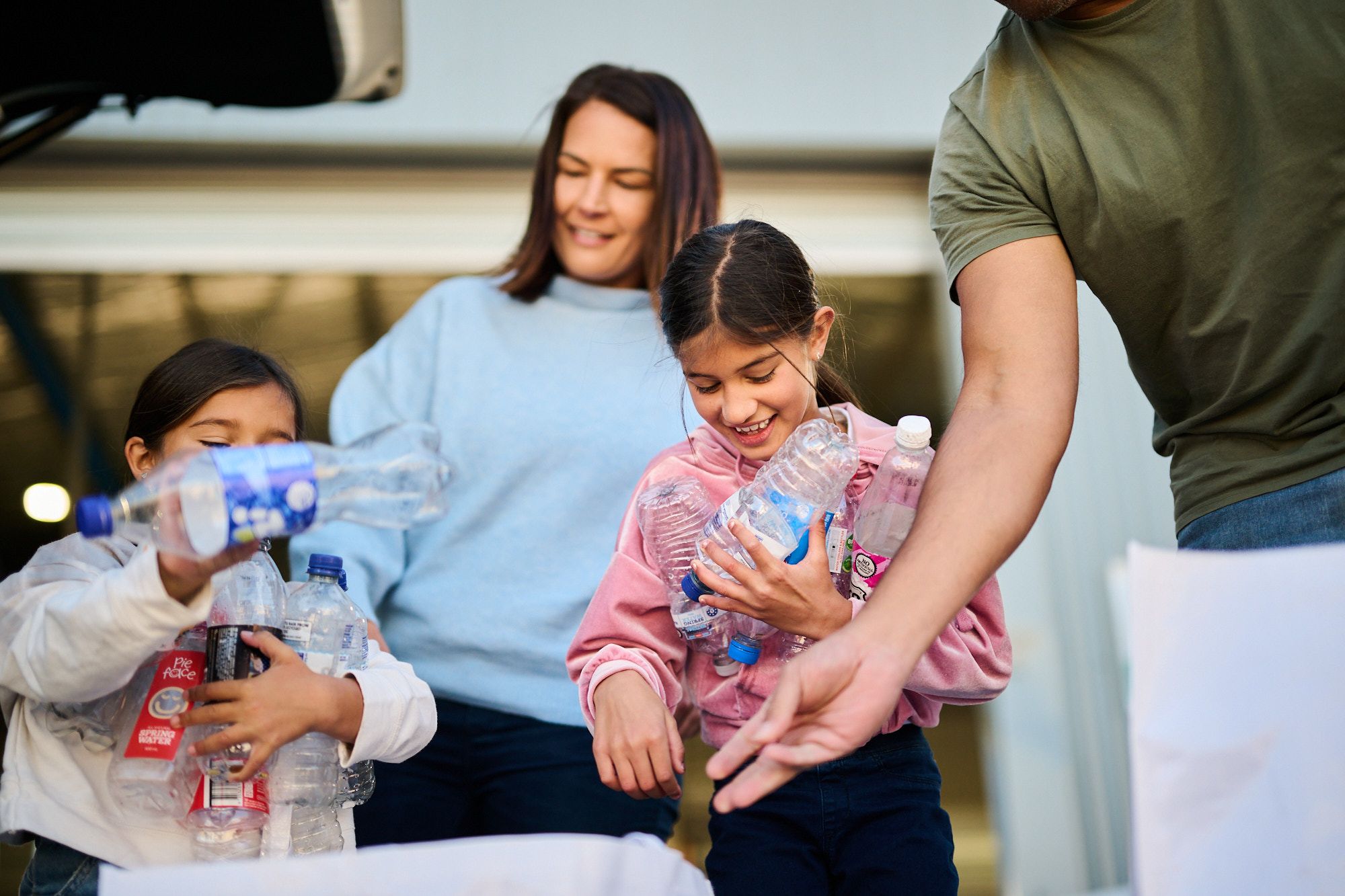 Kids at school holding empty plastic bottles