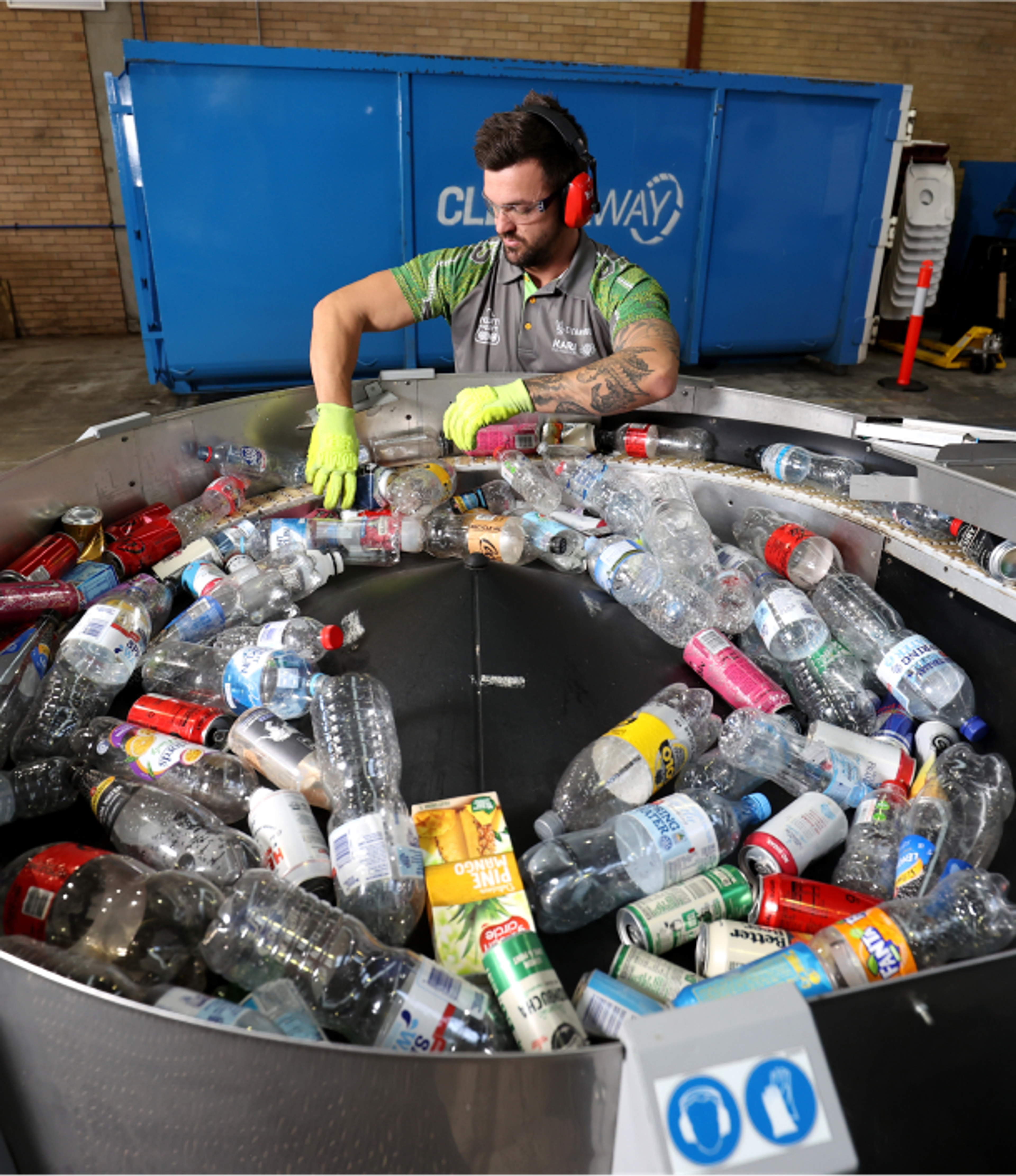 Guy putting bottles into a machine