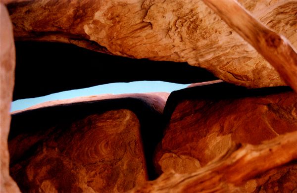 Rock formations framing a narrow opening to the sky