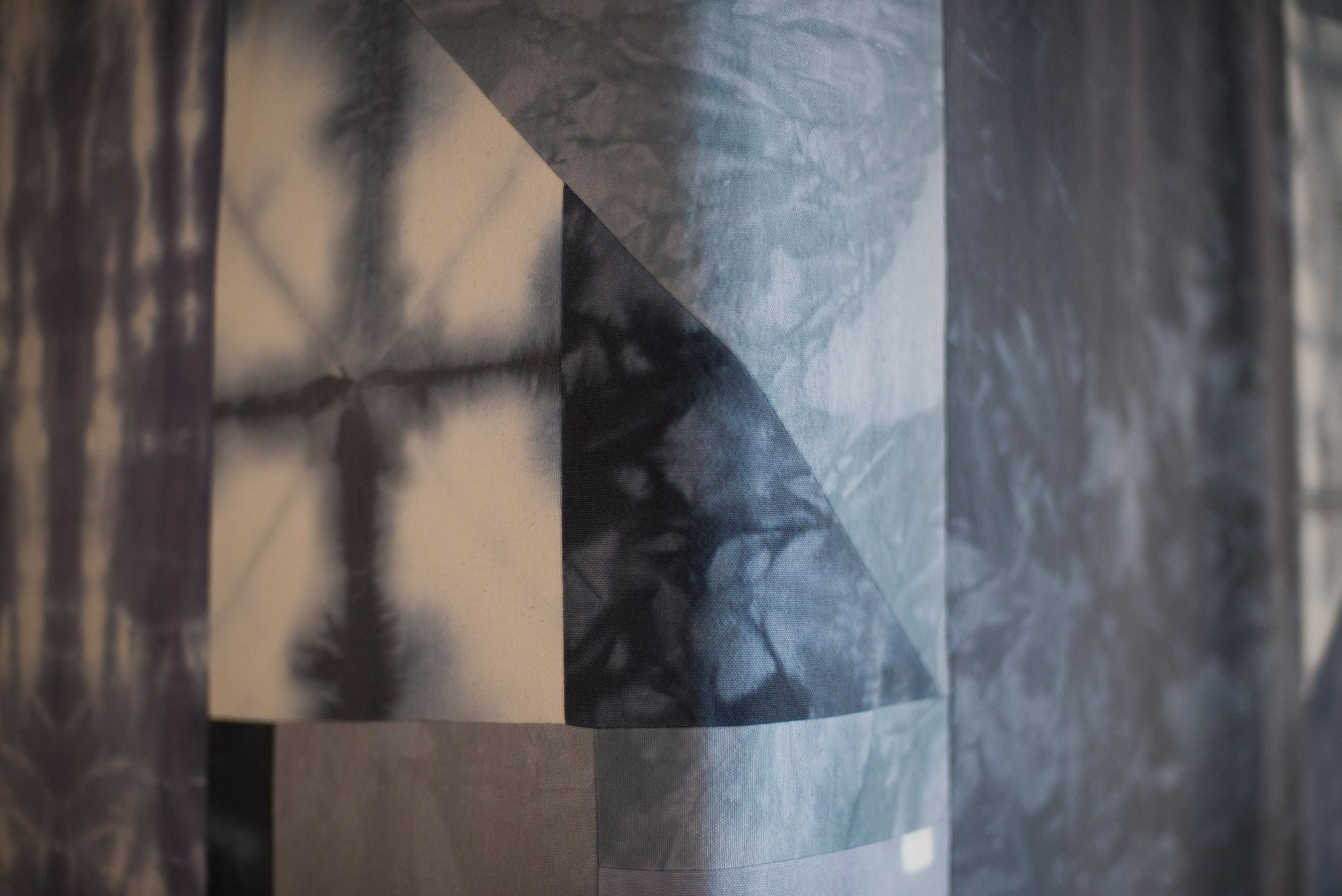 Abstract fabric panel with overlapping geometric and tie-dye patterns