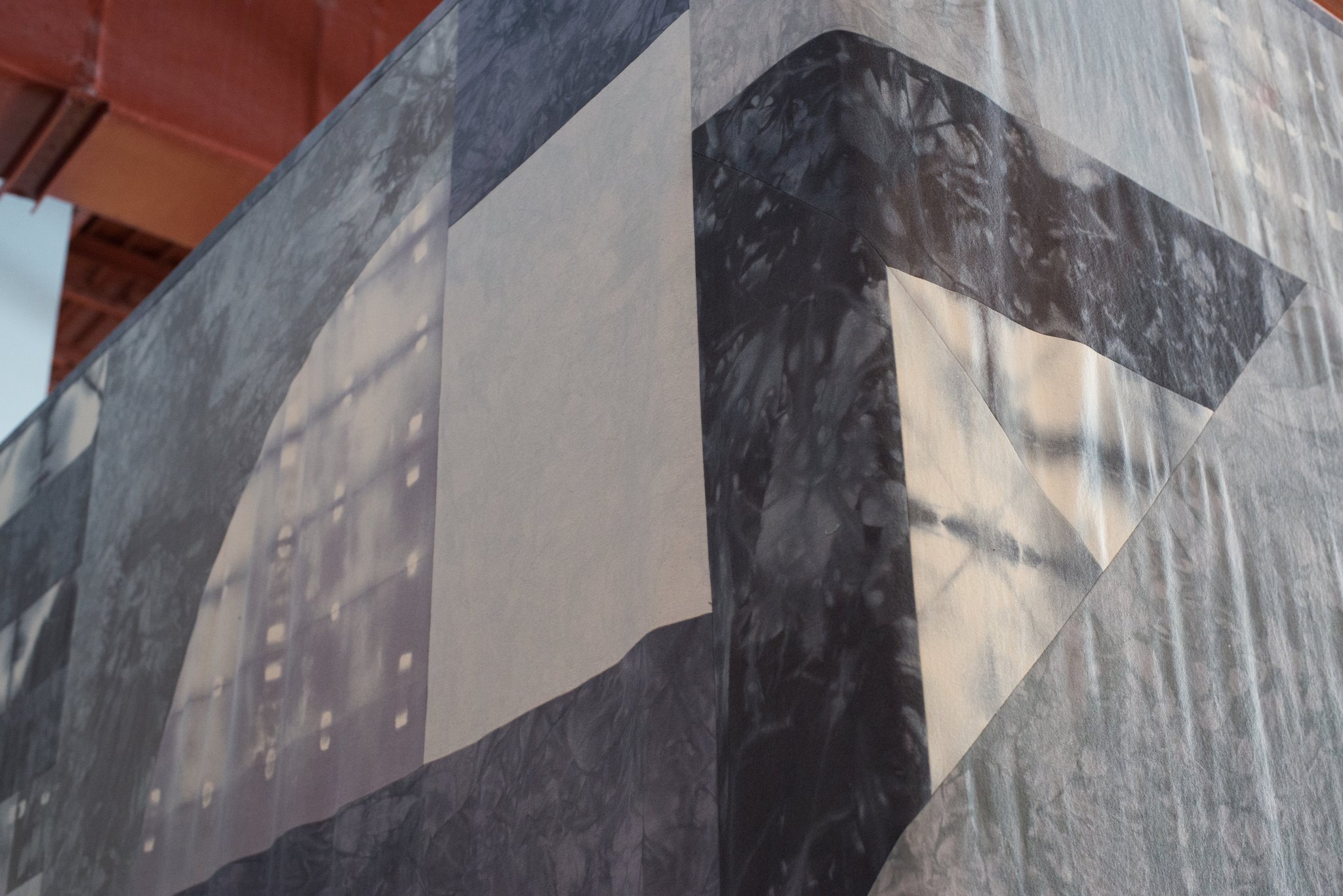 Abstract geometric wall mural with overlapping gray and white shapes