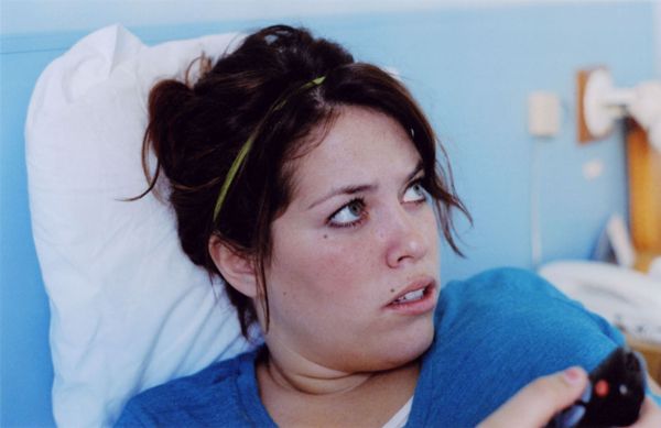 Woman lying in a hospital bed looking to the side