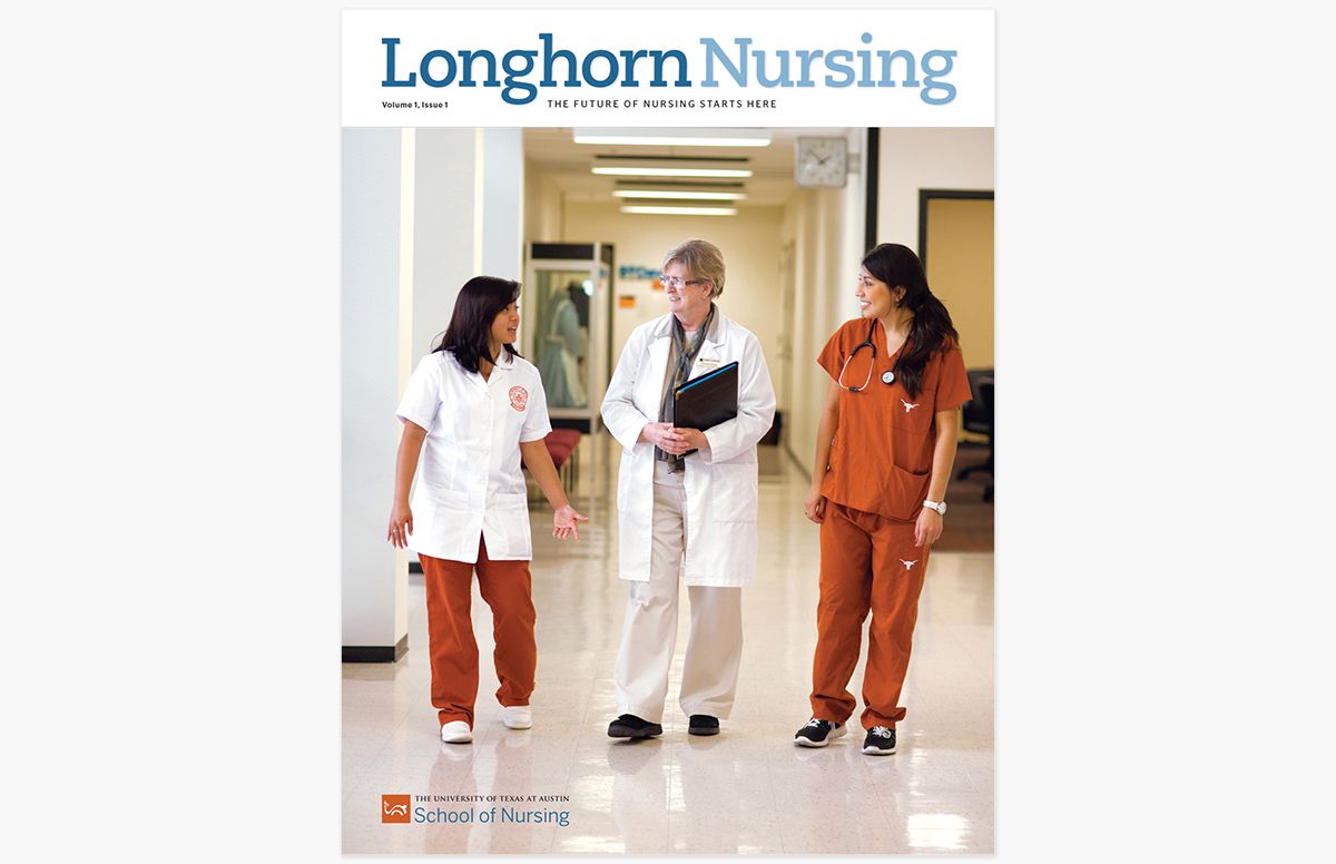 Nursing instructor walking down hallway with two University of Texas students