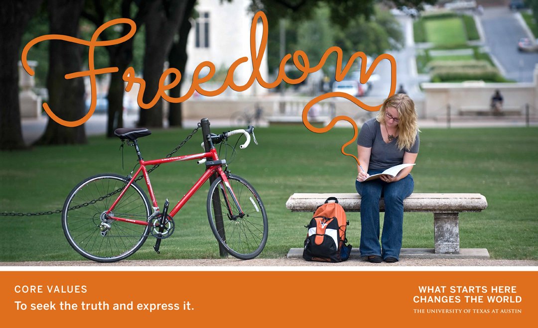 Student reading on campus bench beside bicycle under word “Freedom”