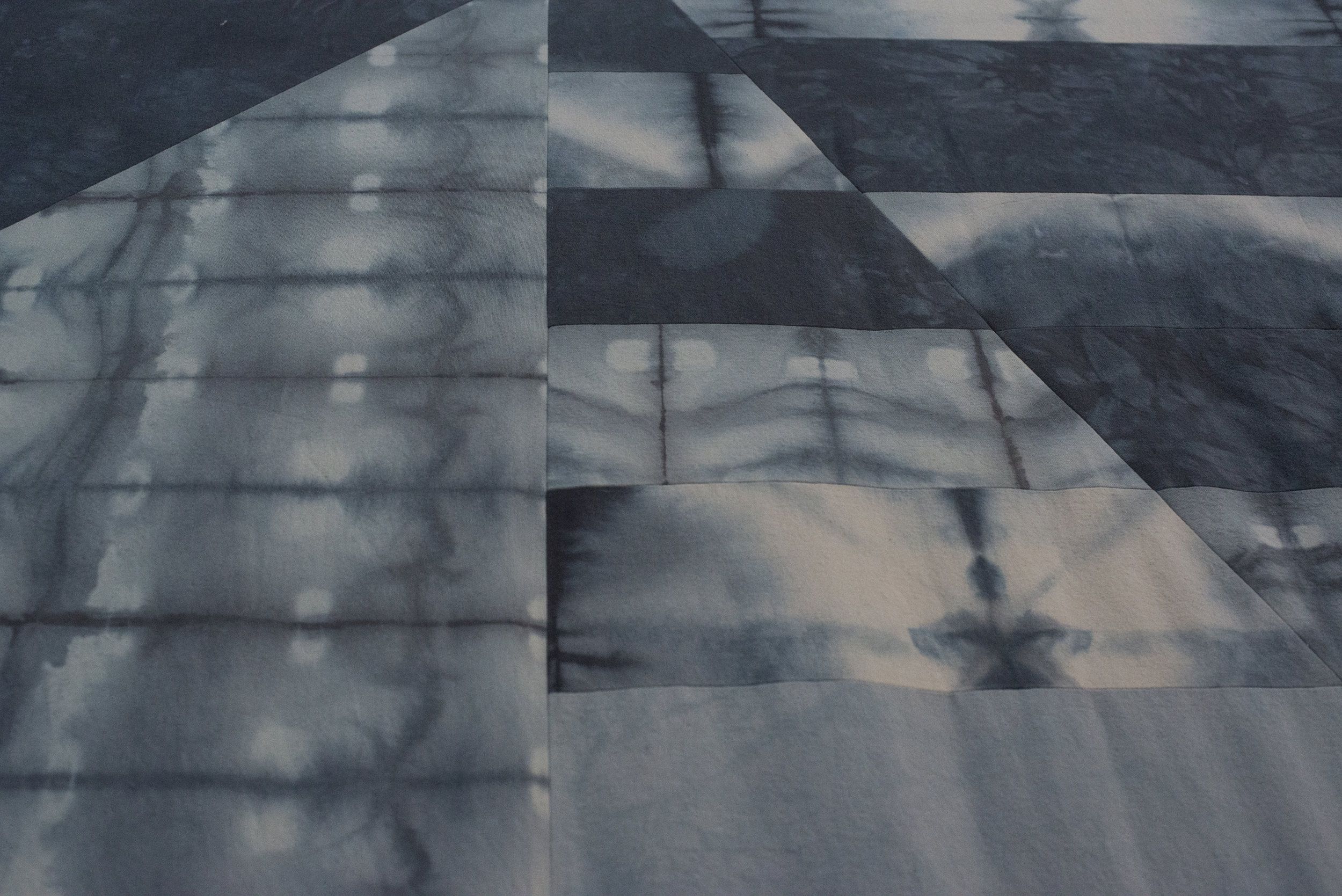 Abstract geometric pattern of overlapping tie-dyed fabric panels