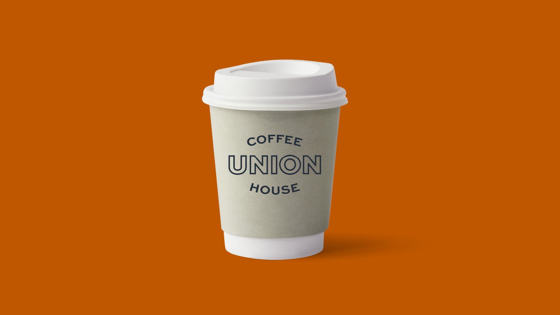 Takeaway coffee cup labeled “Coffee Union House” on plain background