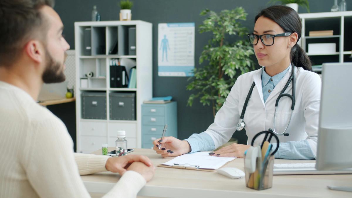 Healthcare professional reviewing a patient case at her desk