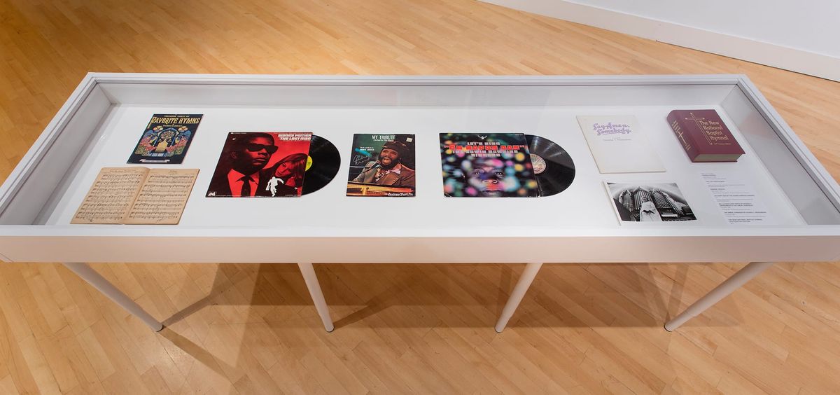 Vitrine view of sheet music and pressed vinyl