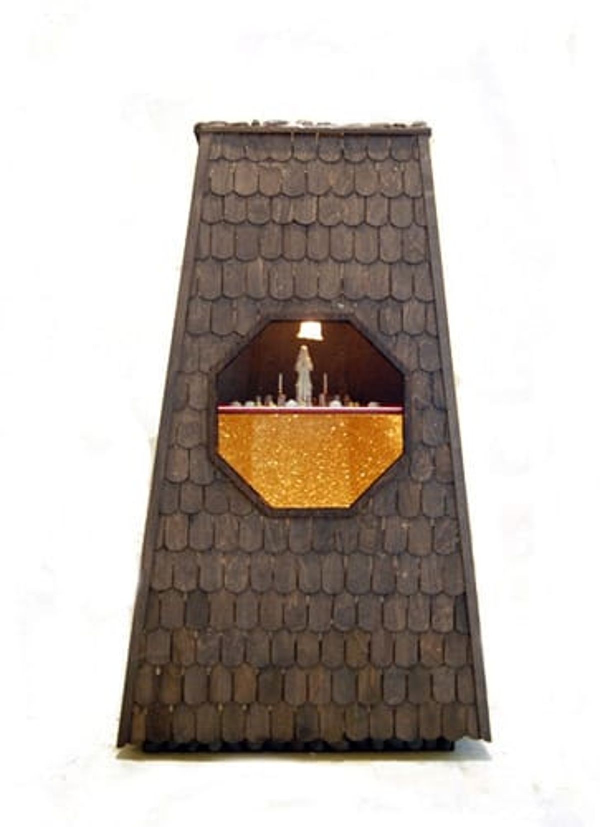 Shingled tower with octagonal window showing miniature living space