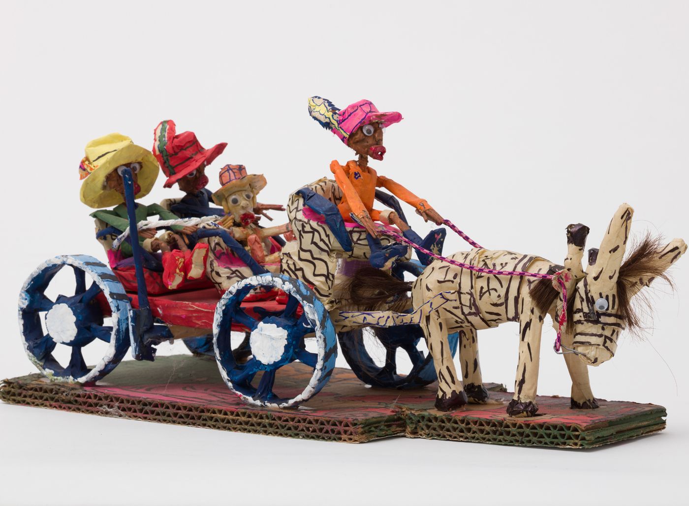 Painted paper-mache sculpture of group in horse drawn carriage