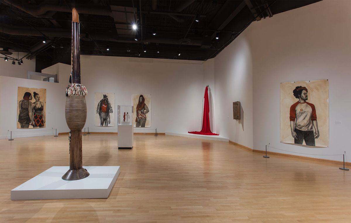 Installation view of paintings, sculpture, and a vitrine