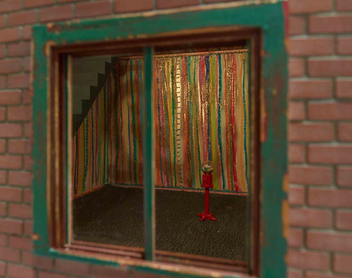 Looking in thru exterior window at multicolor striped wall