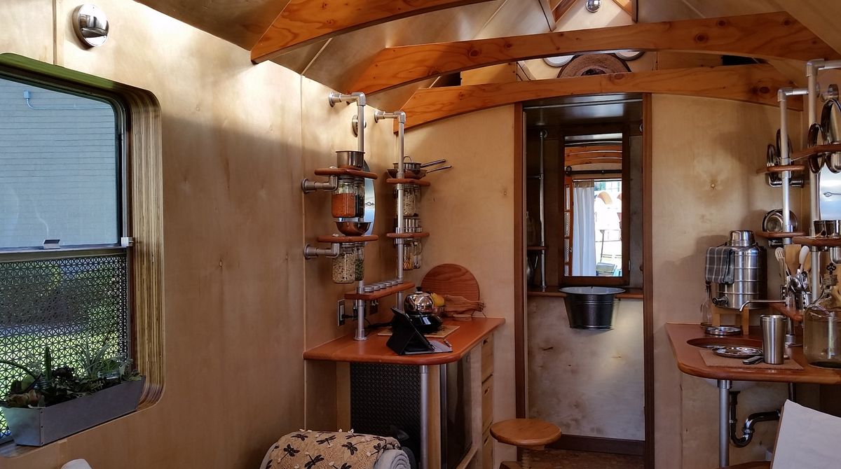 Installation view of interior showing kitchenette, work station, and wash tub