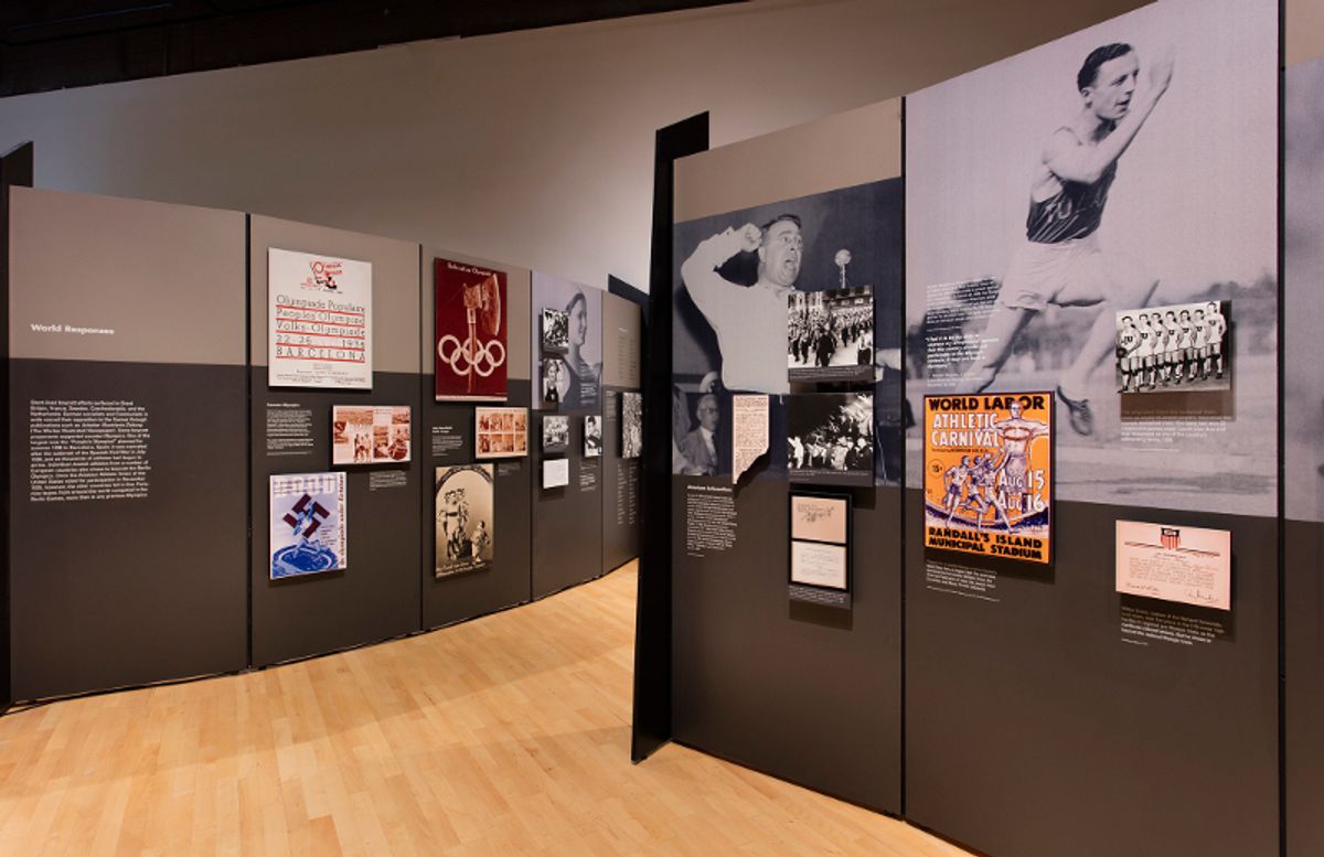 Installation view of wall text, posters from the time, and athlete photos
