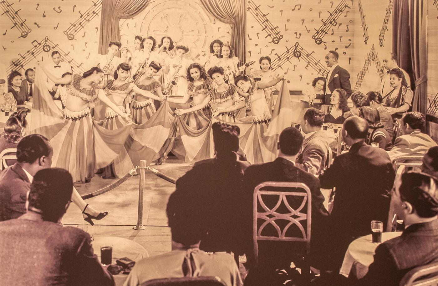Segregated audience watching course of black dancers and band