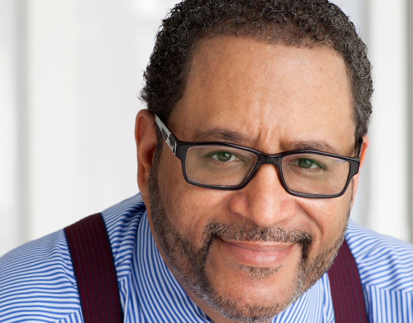 Michael Eric Dyson politely smiling into camera