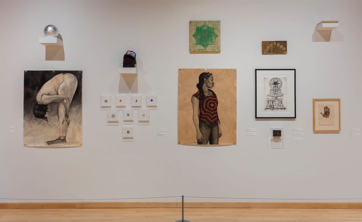 Installation view of paintings and framed works