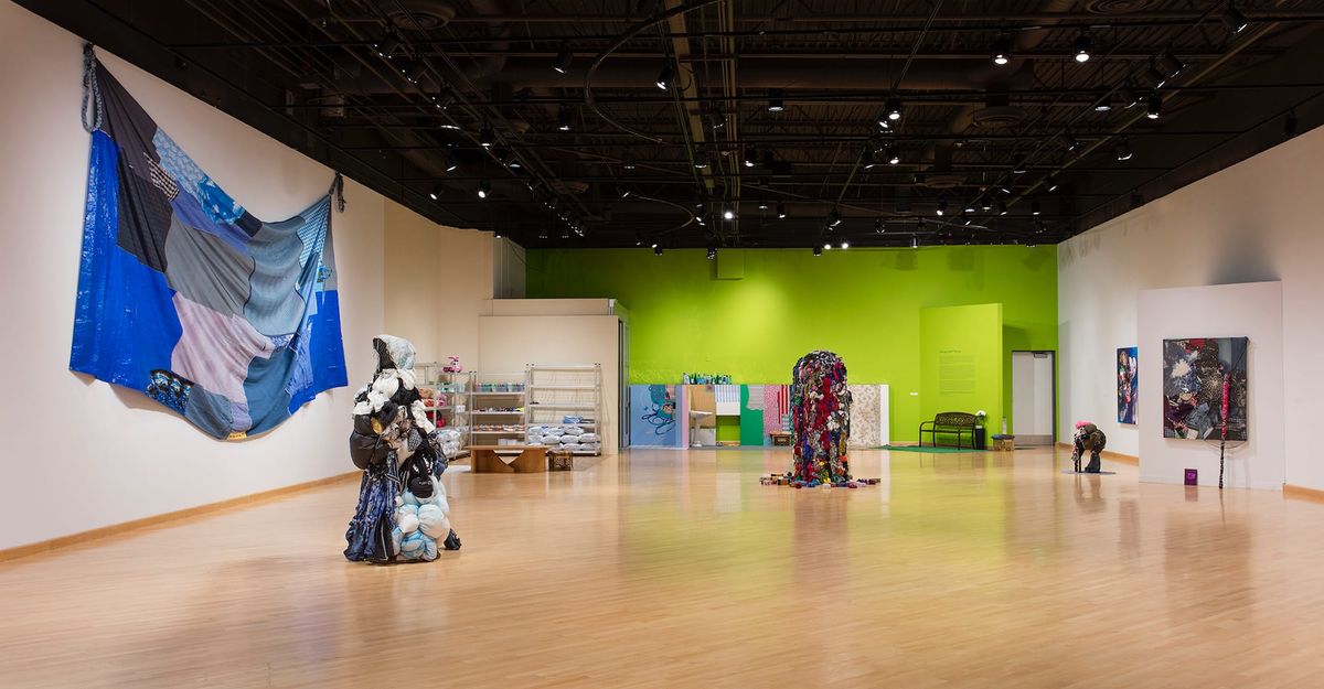 Installation view of sculptures, patchwork, and vignettes