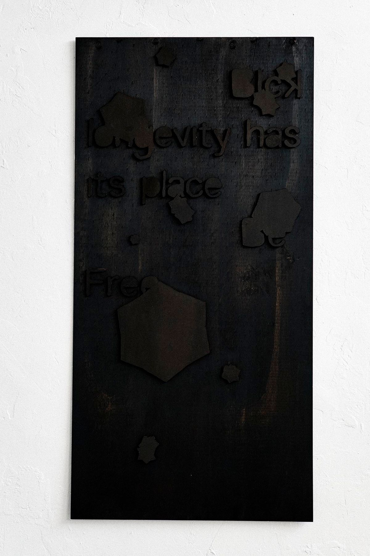 Plywood MDF and wood stain in form of symbolic black rectangle