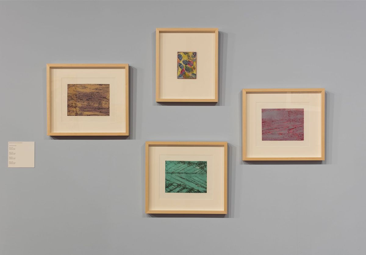 Exhibition view of four framed works