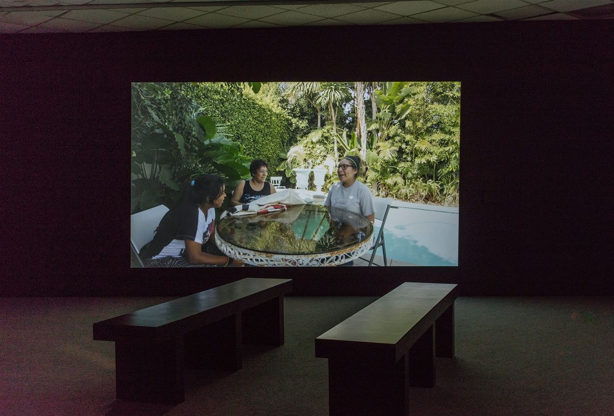 Installation view of large scale monitor and gallery seating