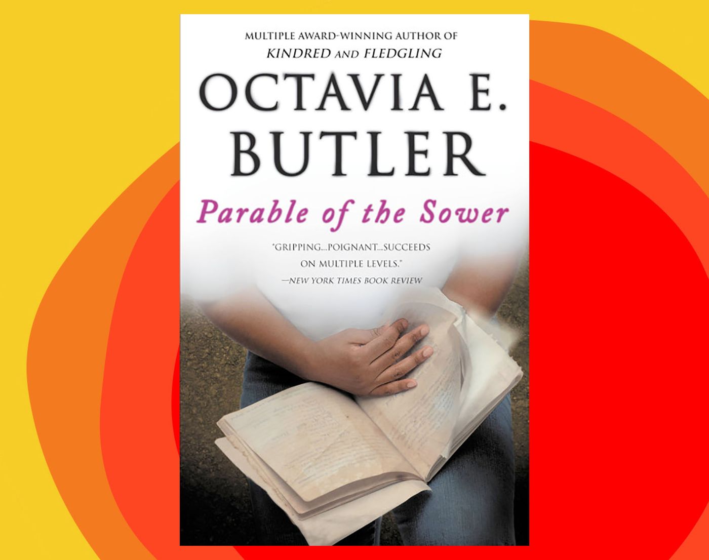 A pair of hands holding a book and turning a page