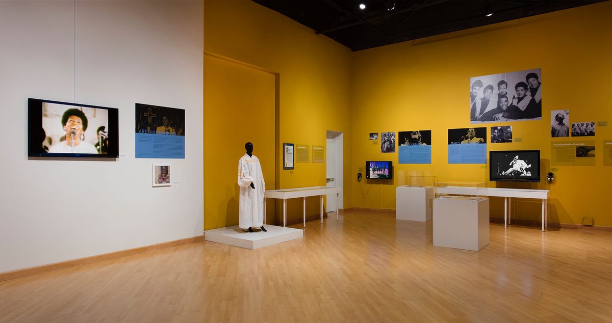 Installation view of monitor, photo elements, audio elements, and vitrines