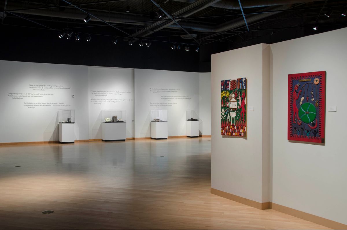 Installation view of paintings and vitrines