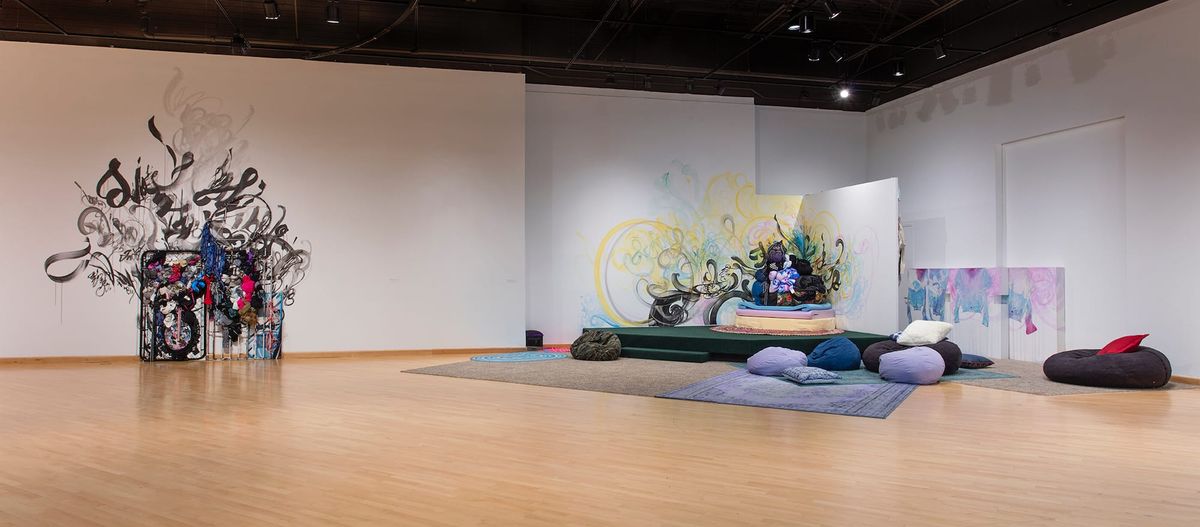 Installation view of mixed media mural and soft furnishings vignette
