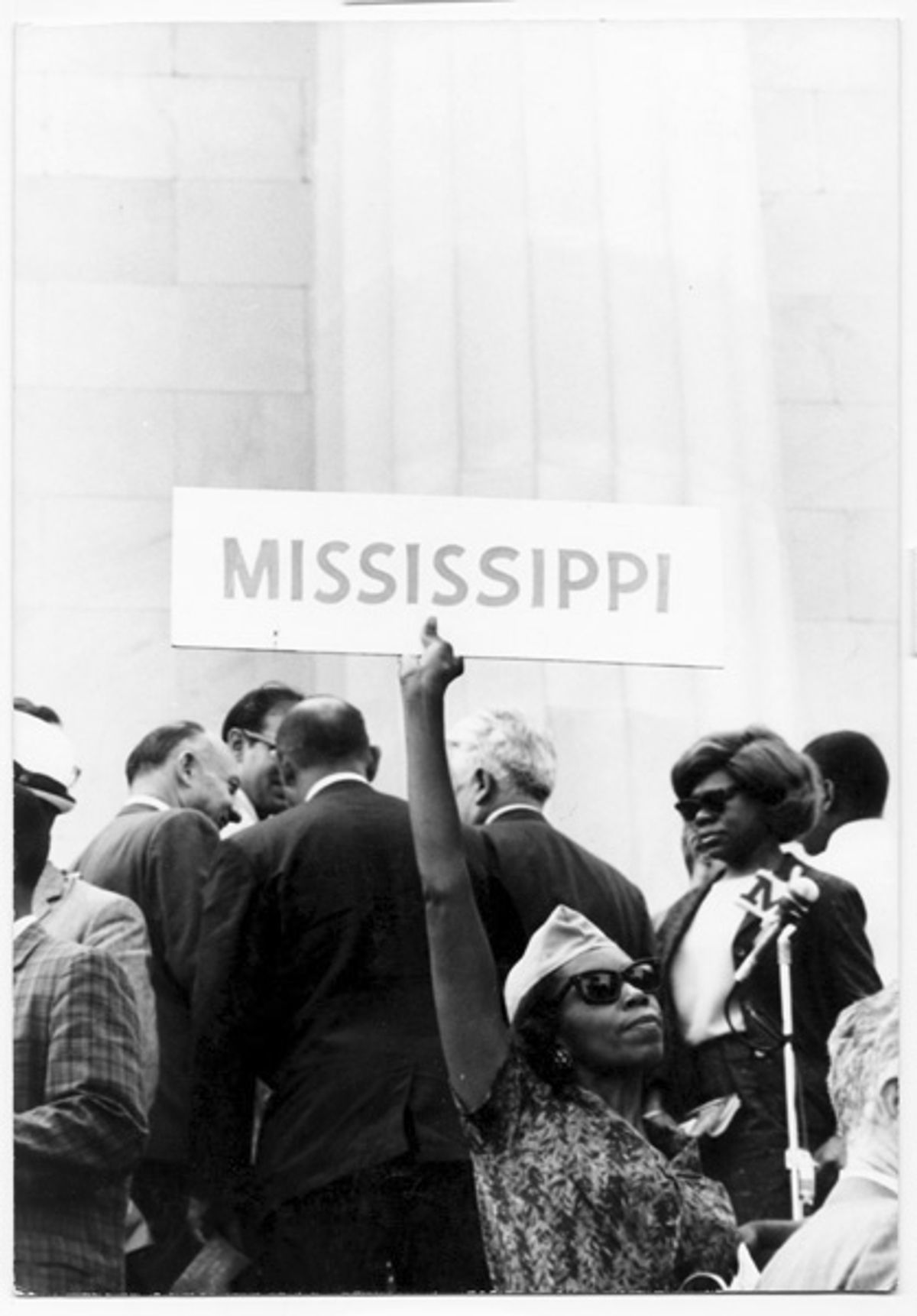 Young woman holding up a sign, "Mississippi"