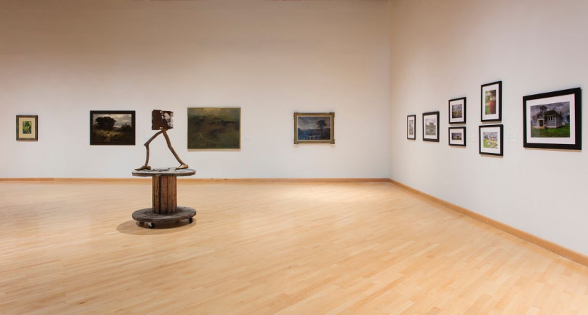 Installation view of framed artworks and sculpture