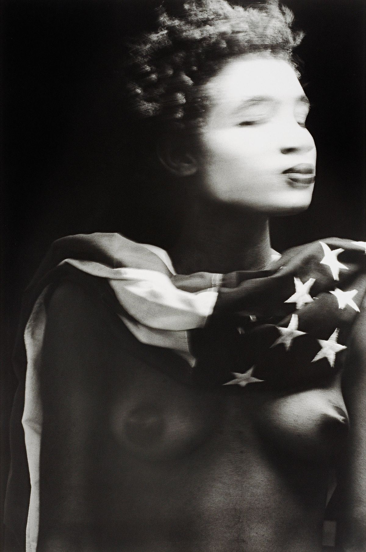 Nude black woman in whiteface wrapped in flag of The States