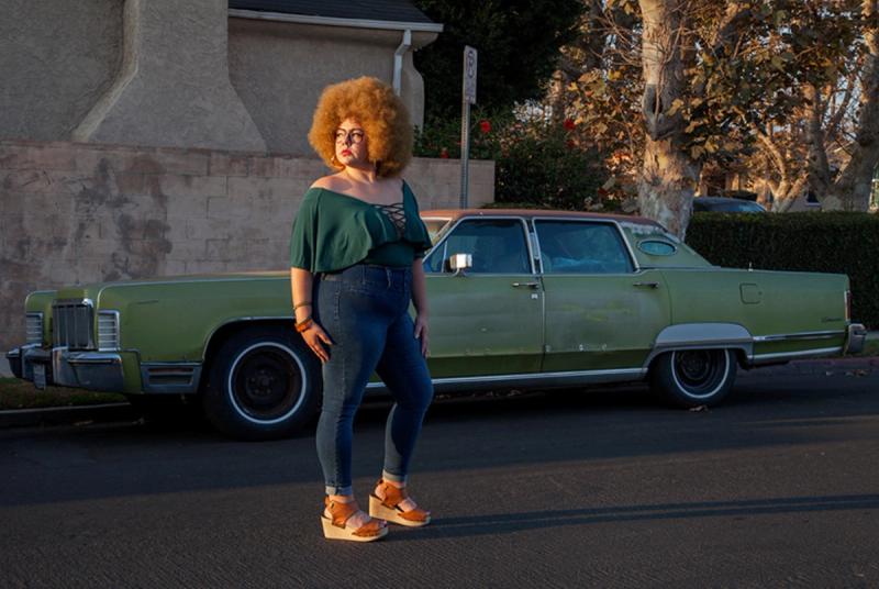 Portrait of Genevieve Gaignard on street with late 70s green Lincoln in background