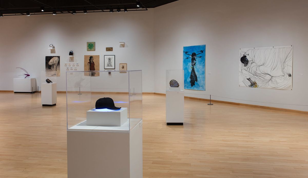 Installation view of paintings and vitrines