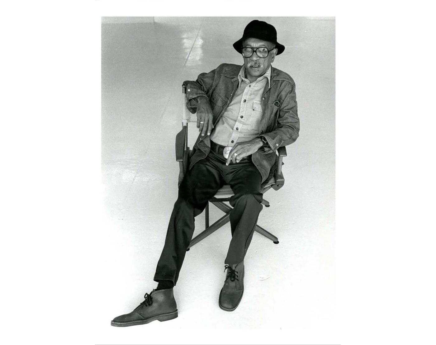 Artist, Charles White wearing fedora and aviator glasses